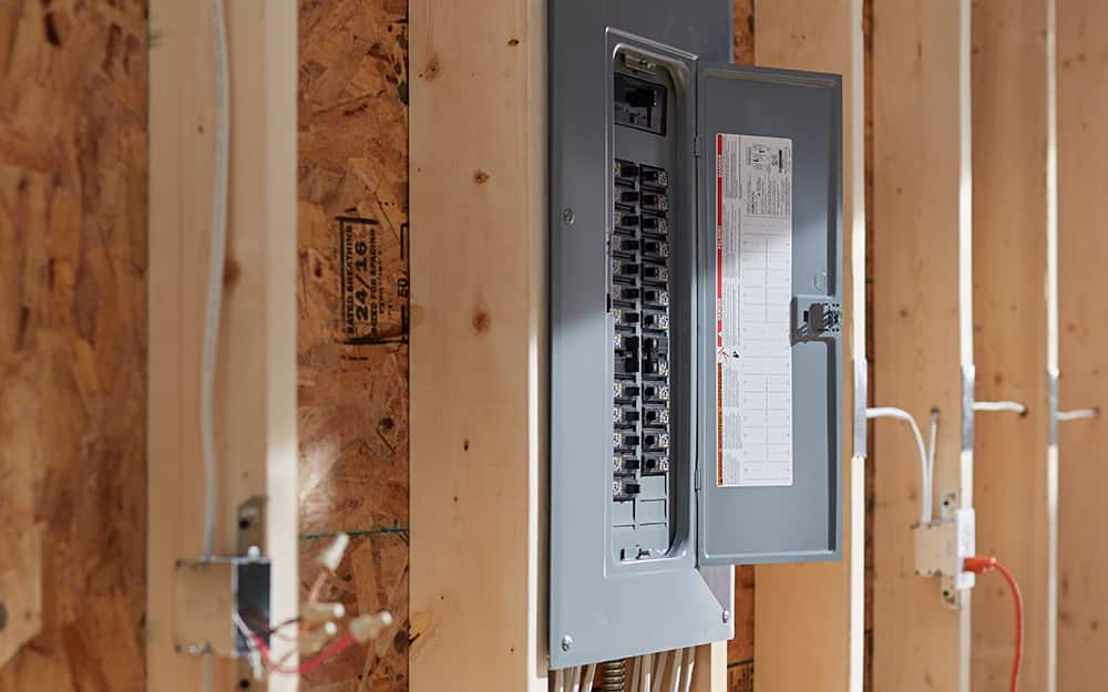 a circuit breaker box against an unfinished wall a circuit breaker box against an unfinished wall