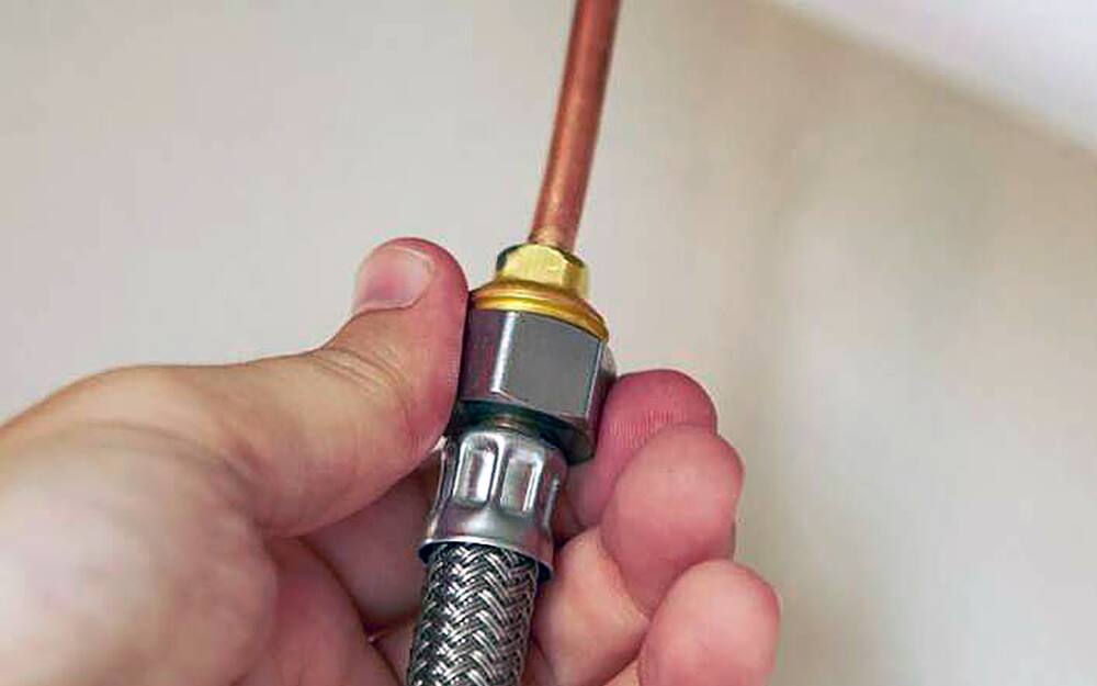 Person loosening mounting nut. Person loosening mounting nut.