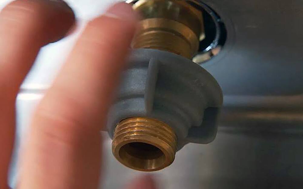 Person attaching mounting nut. Person attaching mounting nut.