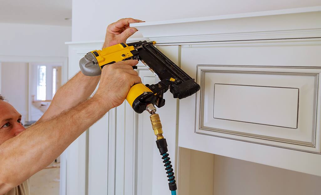 A person hangs a moulding. A person hangs a moulding.