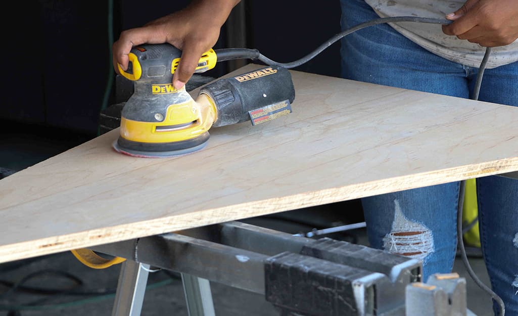 Wood is sanded with an orbital sander. Wood is sanded with an orbital sander.