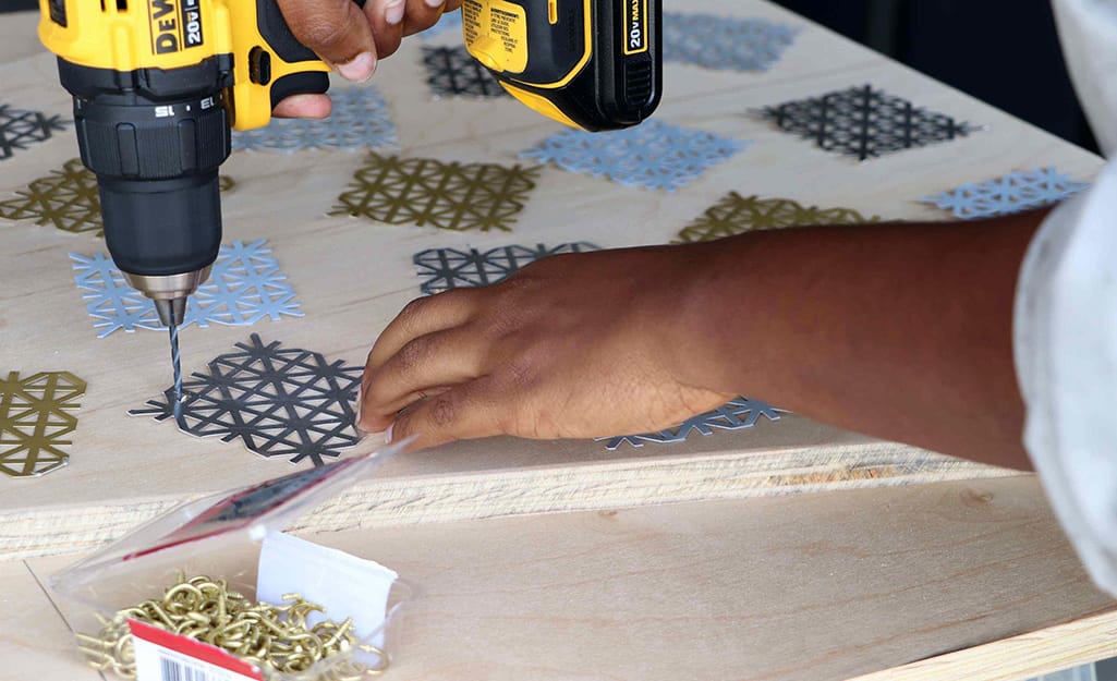 A drill is used to make holes for snowflakes. A drill is used to make holes for snowflakes.