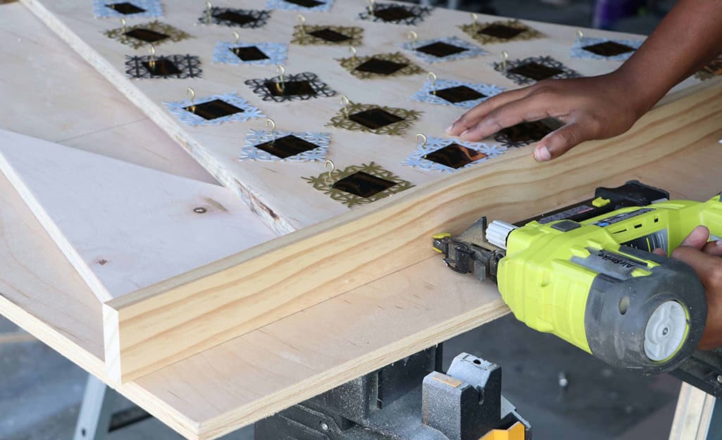 A bottom frame is attached using a nail gun. A bottom frame is attached using a nail gun.