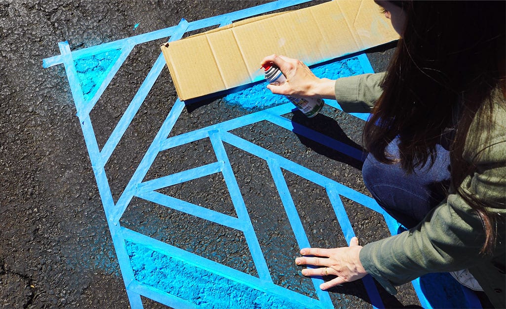 A woman uses a piece of cardboard to keep colors separate in design. A woman uses a piece of cardboard to keep colors separate in design.