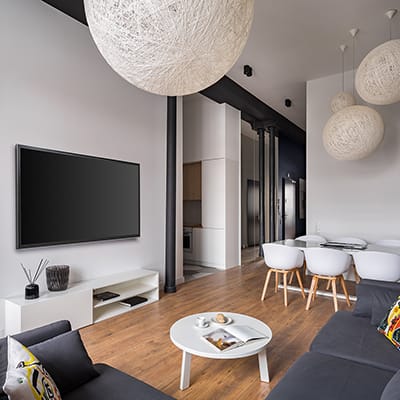 A flat screen TV mounted on a living room wall.