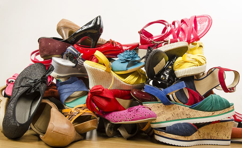 Shoes stacked into a pile. Shoes stacked into a pile.