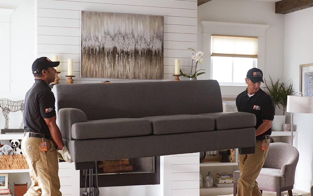 two men moving a couch