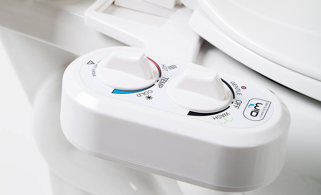 A set of dials on a bidet control the water pressure and temperature. A set of dials on a bidet control the water pressure and temperature.