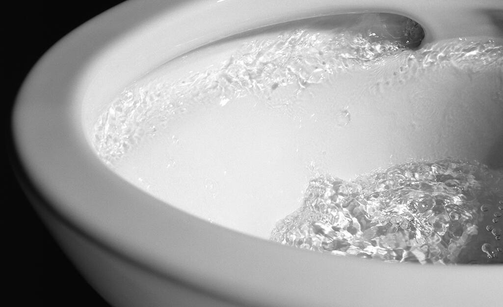Water swirls around the bowl of a bidet. Water swirls around the bowl of a bidet.