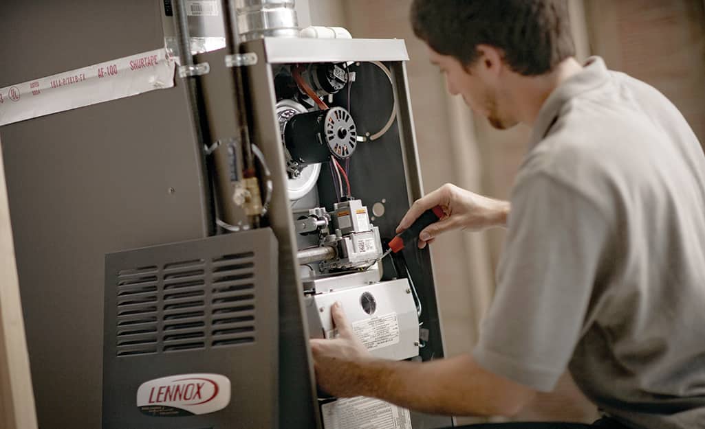 Man inspecting a furnace. Man inspecting a furnace.