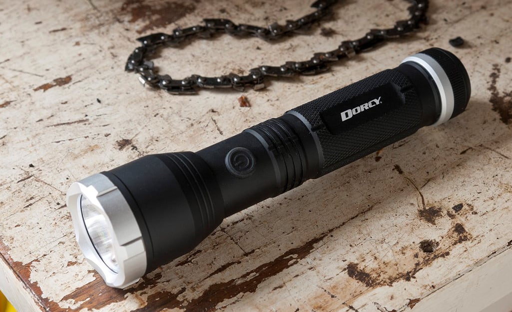 A flashlight laying on the ground. A flashlight laying on the ground.