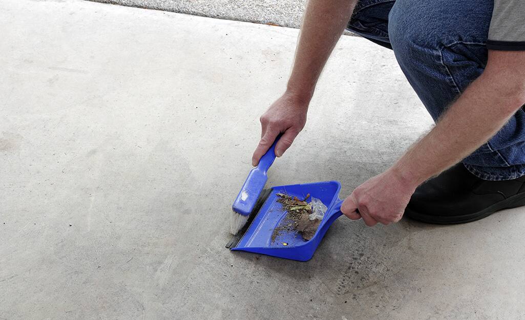 Man sweeping up subfloor before installing tile. Man sweeping up subfloor before installing tile.