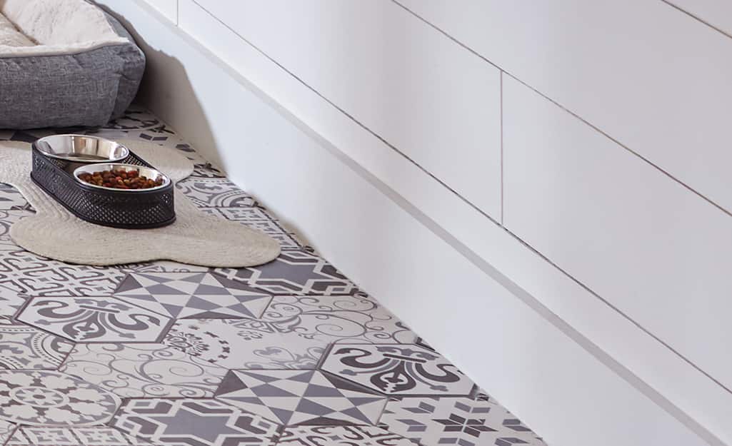 Dog bowl resting on finished tile floor. Dog bowl resting on finished tile floor.