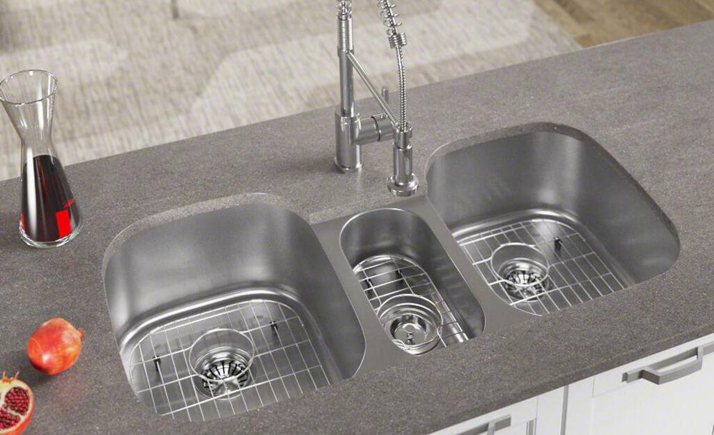 A triple bowl stainless steel kitchen sink.