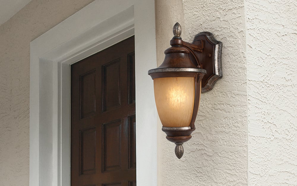 An outdoor wall light on an exterior wall of a house. An outdoor wall light on an exterior wall of a house.