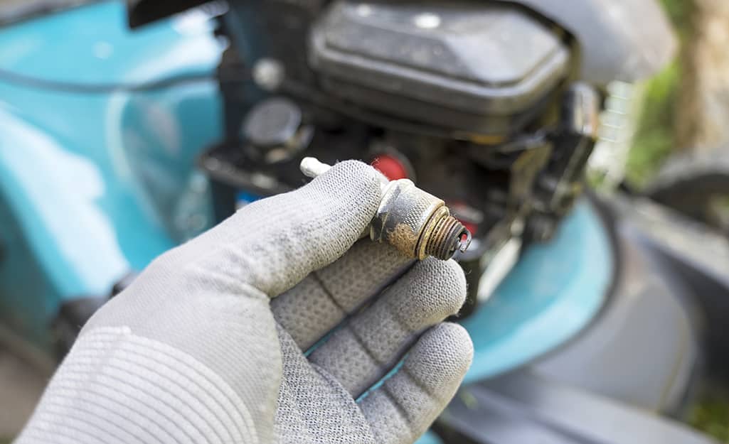 Someone changing a spark plug. Someone changing a spark plug.