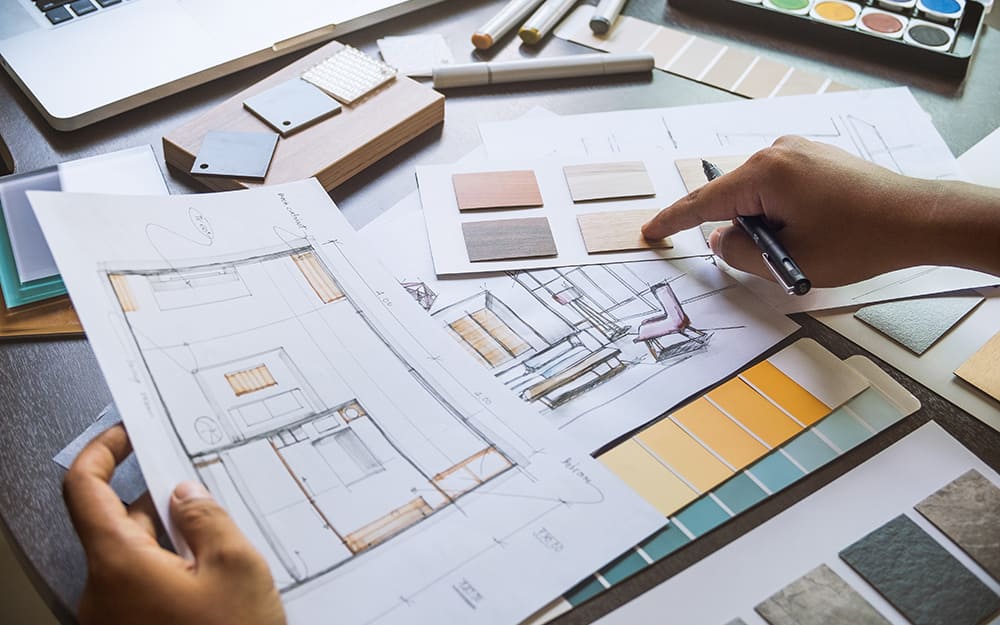 A person looking a interior design plans. A person looking a interior design plans.
