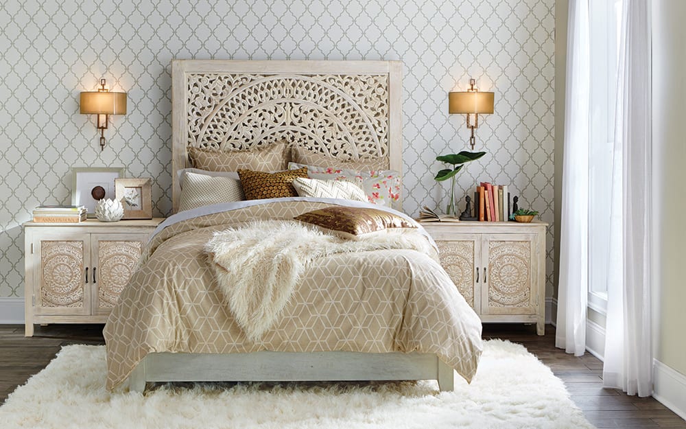 Carved headboard and matching nightstands used in a neutral bedroom. Carved headboard and matching nightstands used in a neutral bedroom.