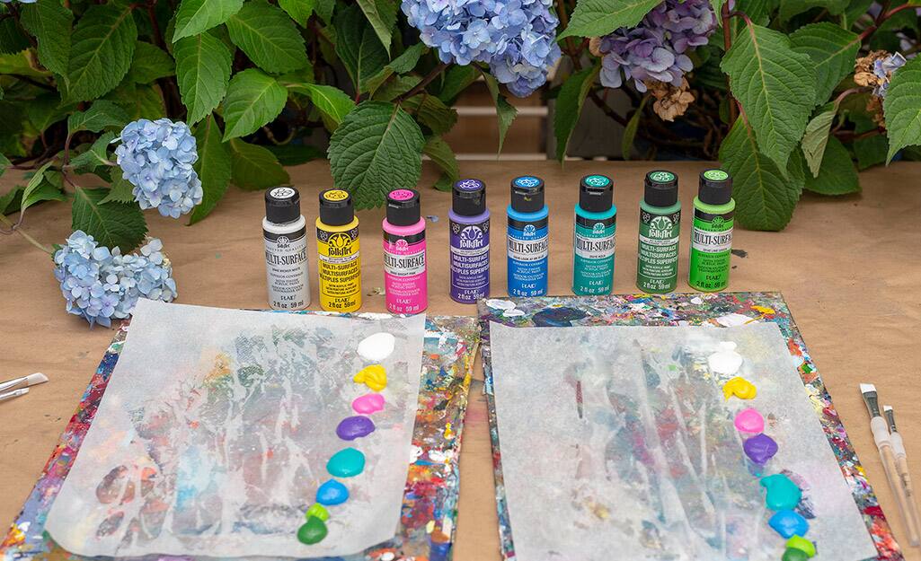 A collection of acrylic paint on a table. A collection of acrylic paint on a table.