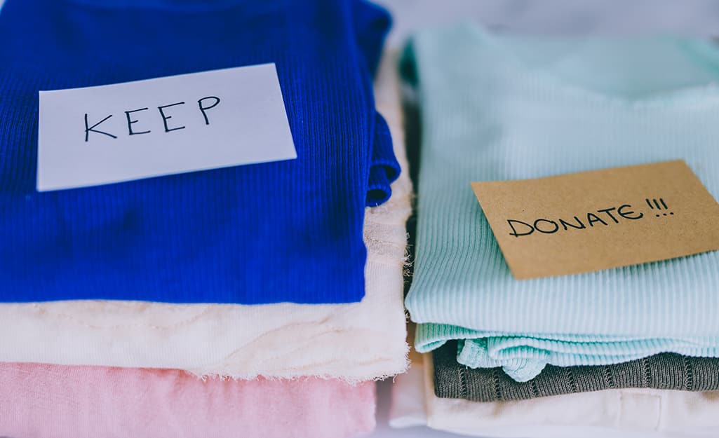 Items separated into stacks to keep and for donating. Items separated into stacks to keep and for donating.