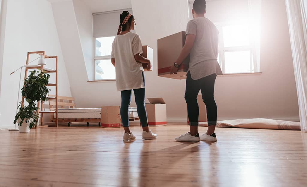 People carrying the last remaining moving boxes from a room. People carrying the last remaining moving boxes from a room.