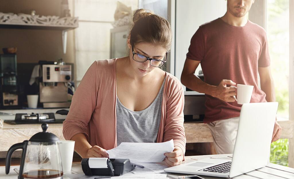 Couple in kitchen meeting about moving project. Couple in kitchen meeting about moving project.