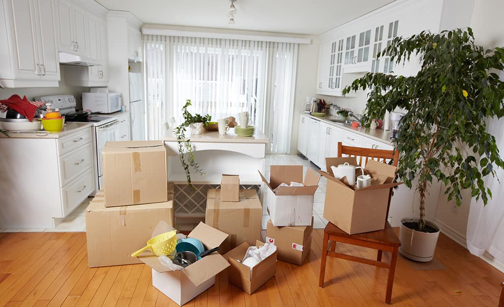 A kitchen filled with different moving boxes. A kitchen filled with different moving boxes.