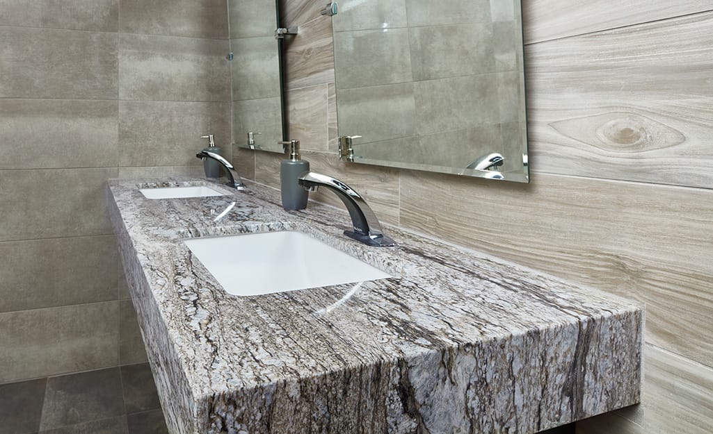 Thick natural stone granite countertop in a bathroom. Thick natural stone granite countertop in a bathroom.