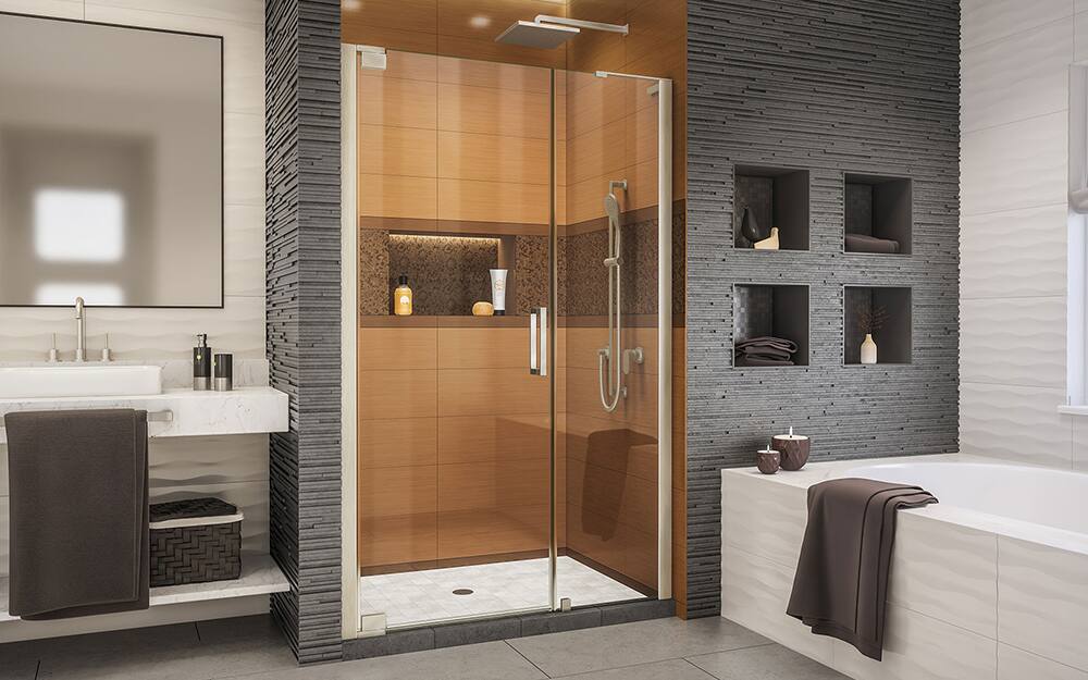 A bathroom with a walk-in shower that has a pivot shower door. A bathroom with a walk-in shower that has a pivot shower door.