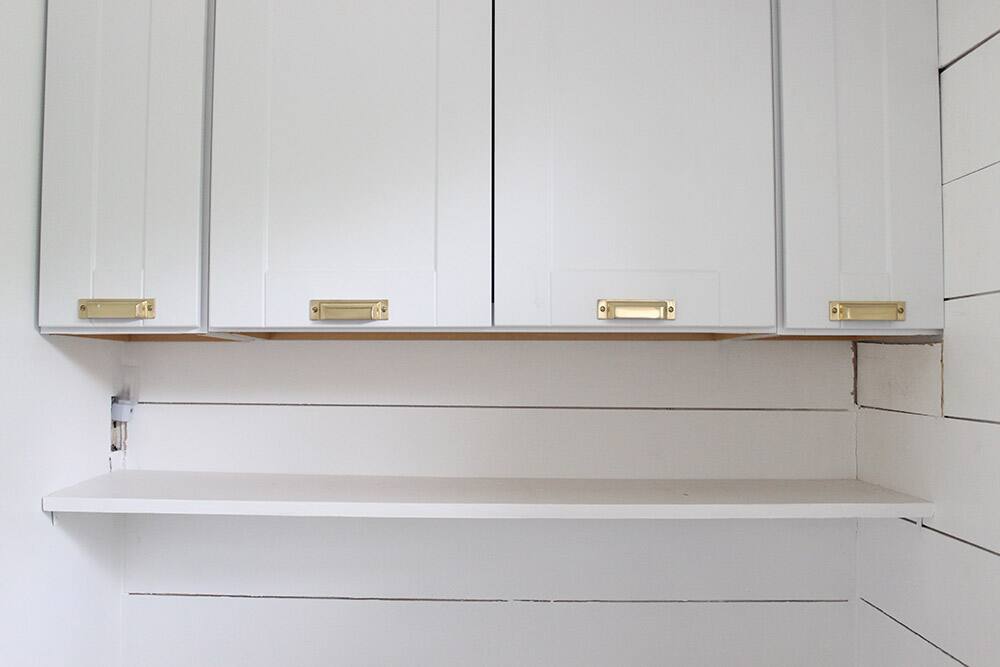 White cabinets with gold hardware.