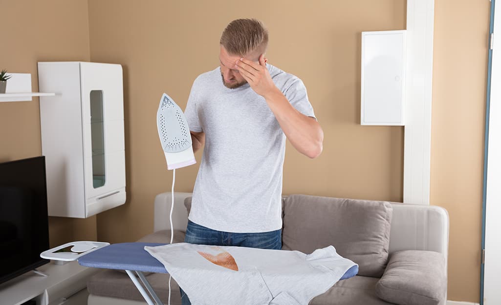 A man holding an iron. A man holding an iron.