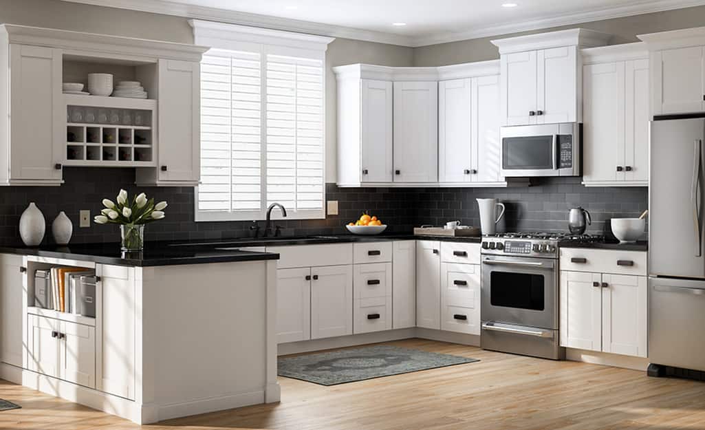 A kitchen with white cabinets and black countertops. A kitchen with white cabinets and black countertops.
