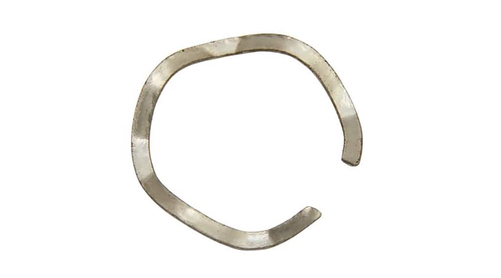 A wave spring washer on a white background. A wave spring washer on a white background.