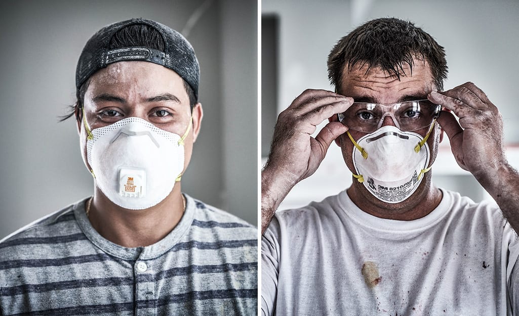 Two men wearing different types of masks. Two men wearing different types of masks.