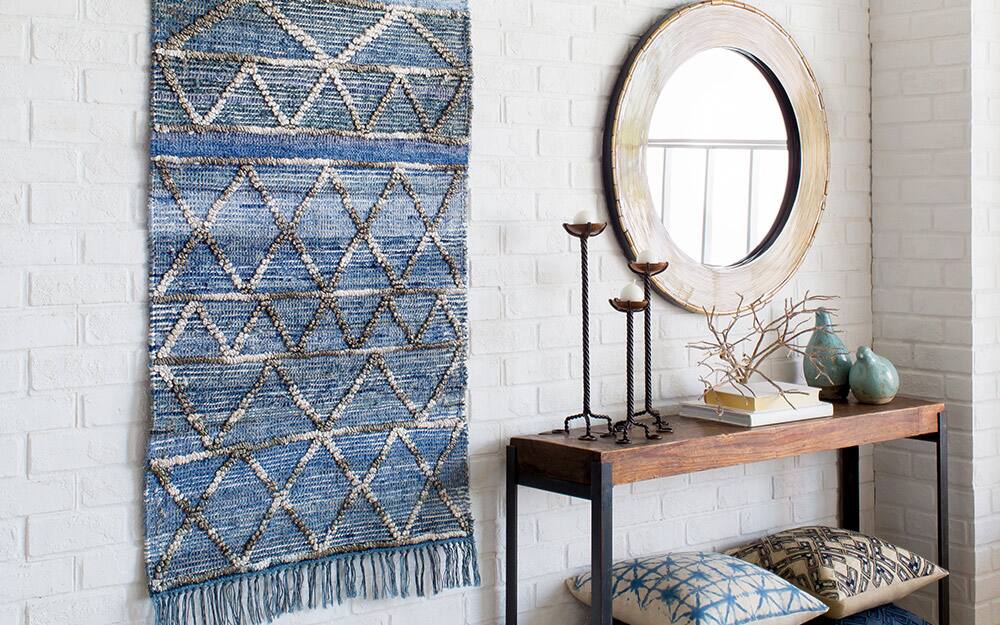  A woven rug hung on a wall as wall art.