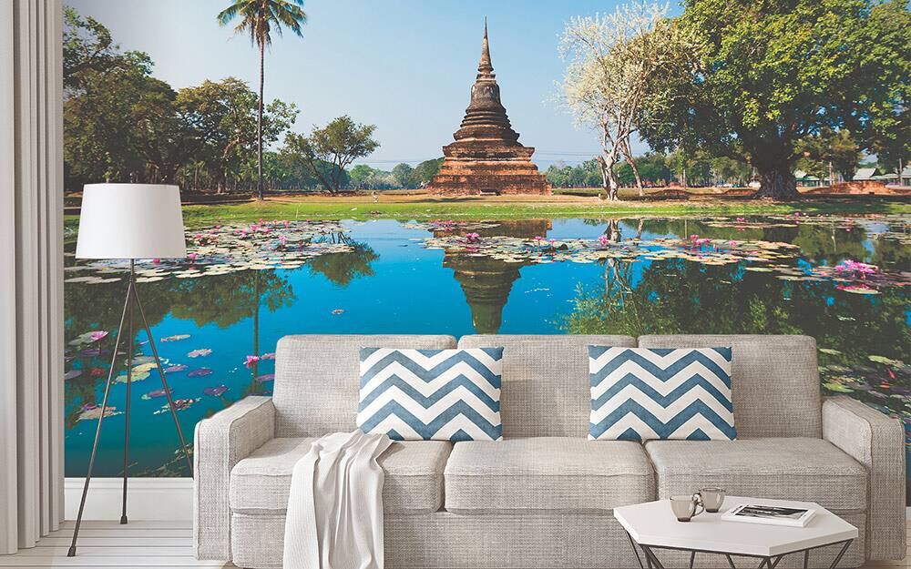 A large, scenic mural used as wall art behind a sofa.