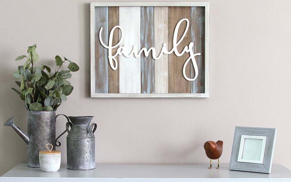 A framed sign reading "family" hung as wall art.