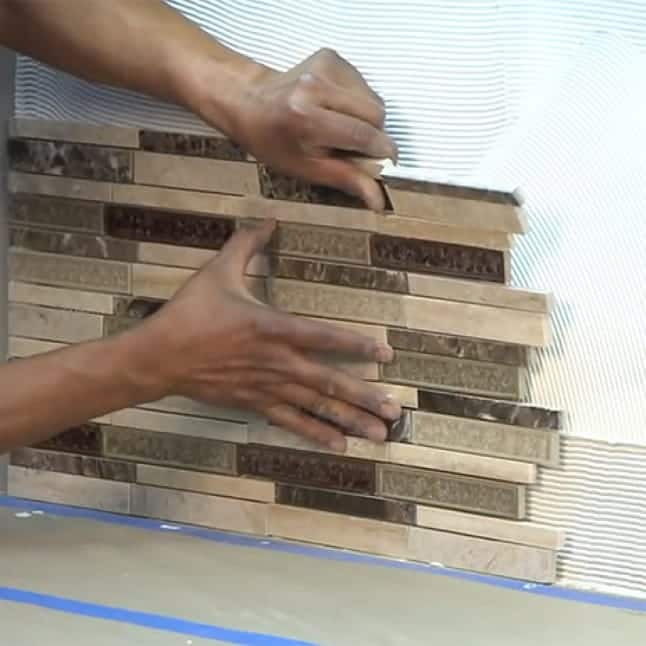 An image showing installation of the mosaic sheets.