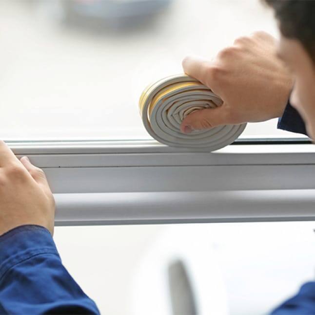 A man installs his AC unit