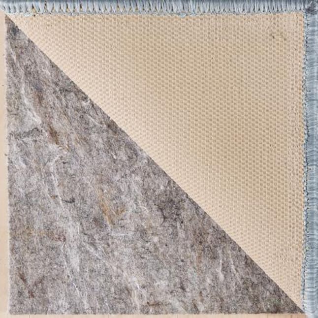 The image is entirely made up of the corner of a rug being pulled back to show the rug pad underneath. The serge is a light blue.